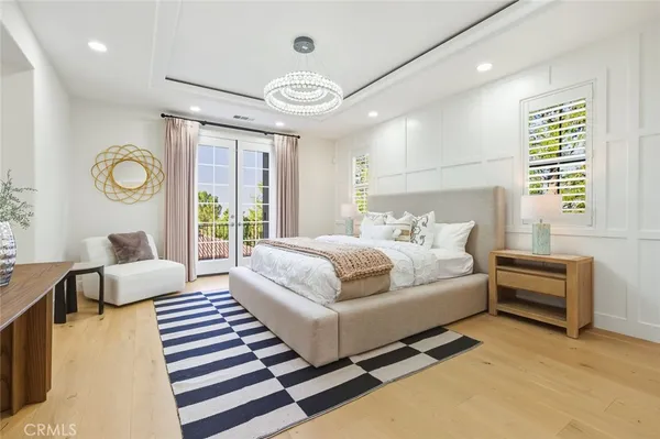 a bedroom with a bed couch and a large window