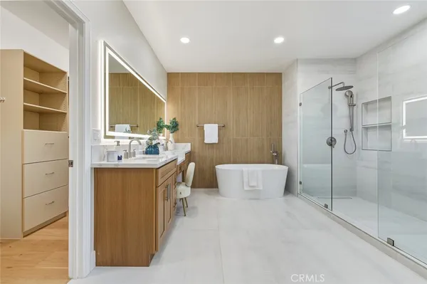 a bathroom with a double vanity sink toilet and shower