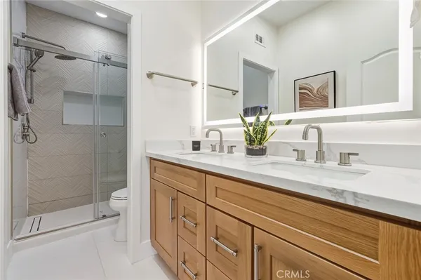 a bathroom with a shower sink and toilet