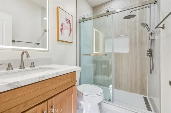a bathroom with a sink toilet and shower