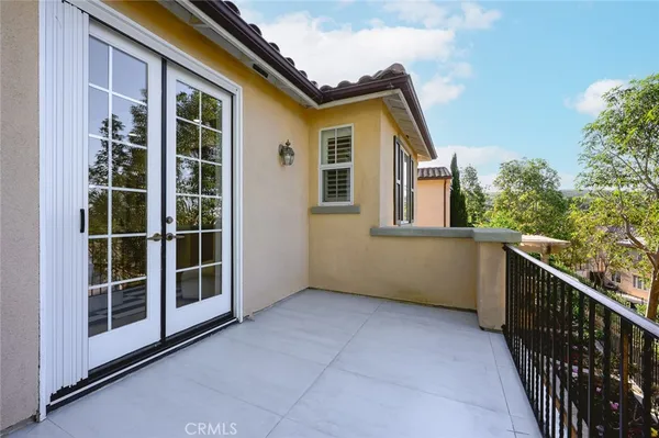 a view of house with a large window and wooden fence