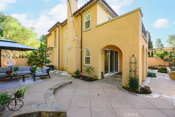 a front view of a house with garden and patio