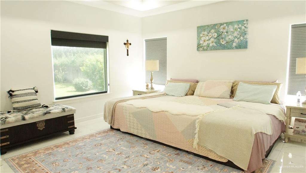 414 Ric Mar Street Edinburg, TX 78541 - Photo 21 of 36 Spacious room featuring white walls, high ceilings, large windows with roller shades, and light-colored flooring
