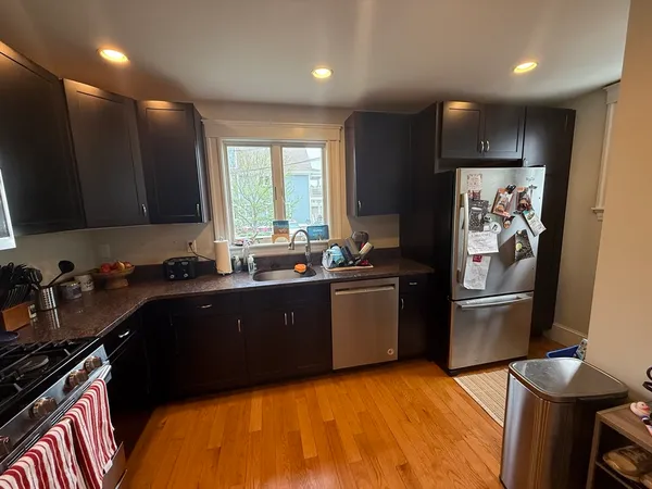 a kitchen with a sink appliances and cabinets