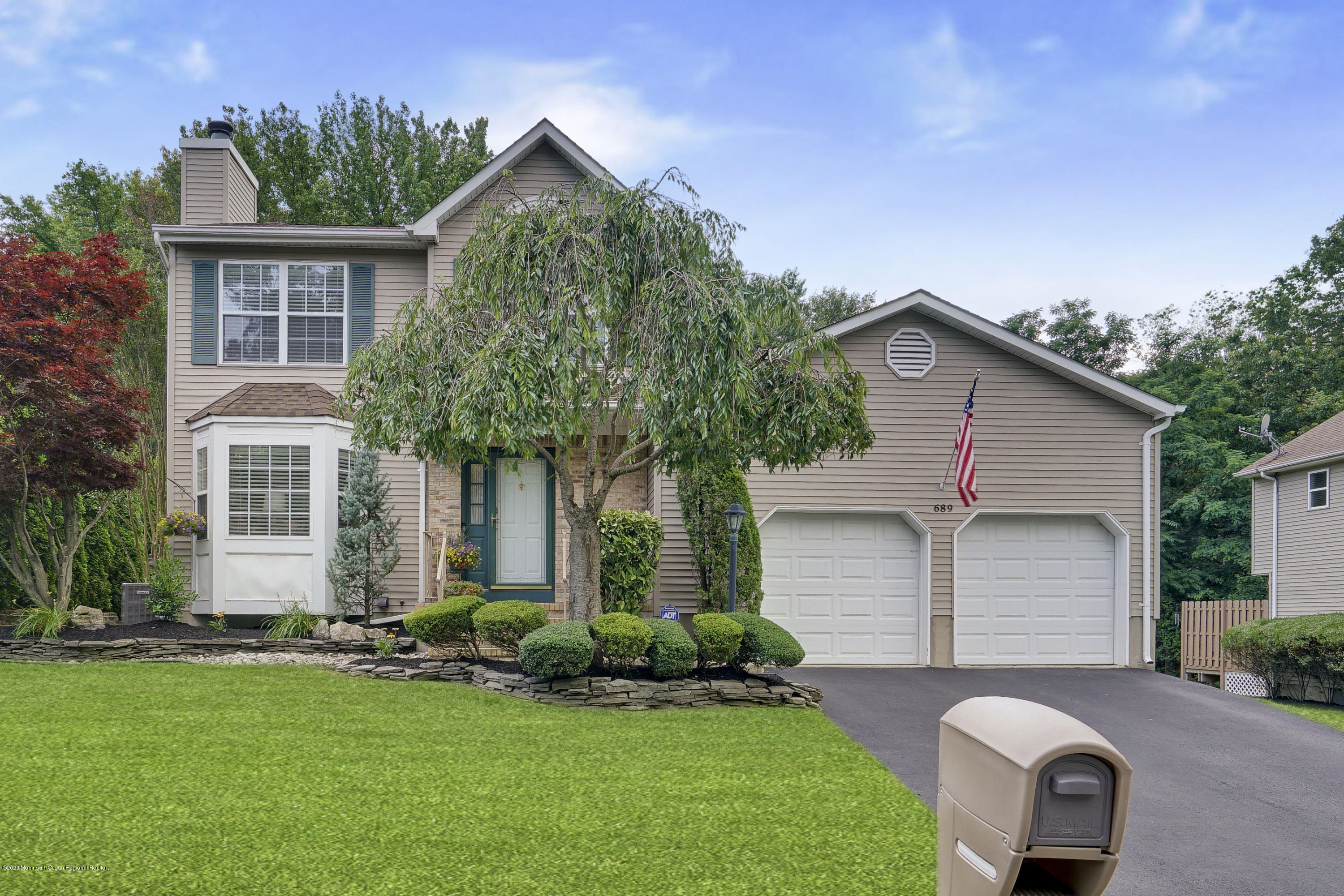 689 Line Road Matawan, NJ 07747 - Photo 1 of 25 a front view of house with a garden and plants