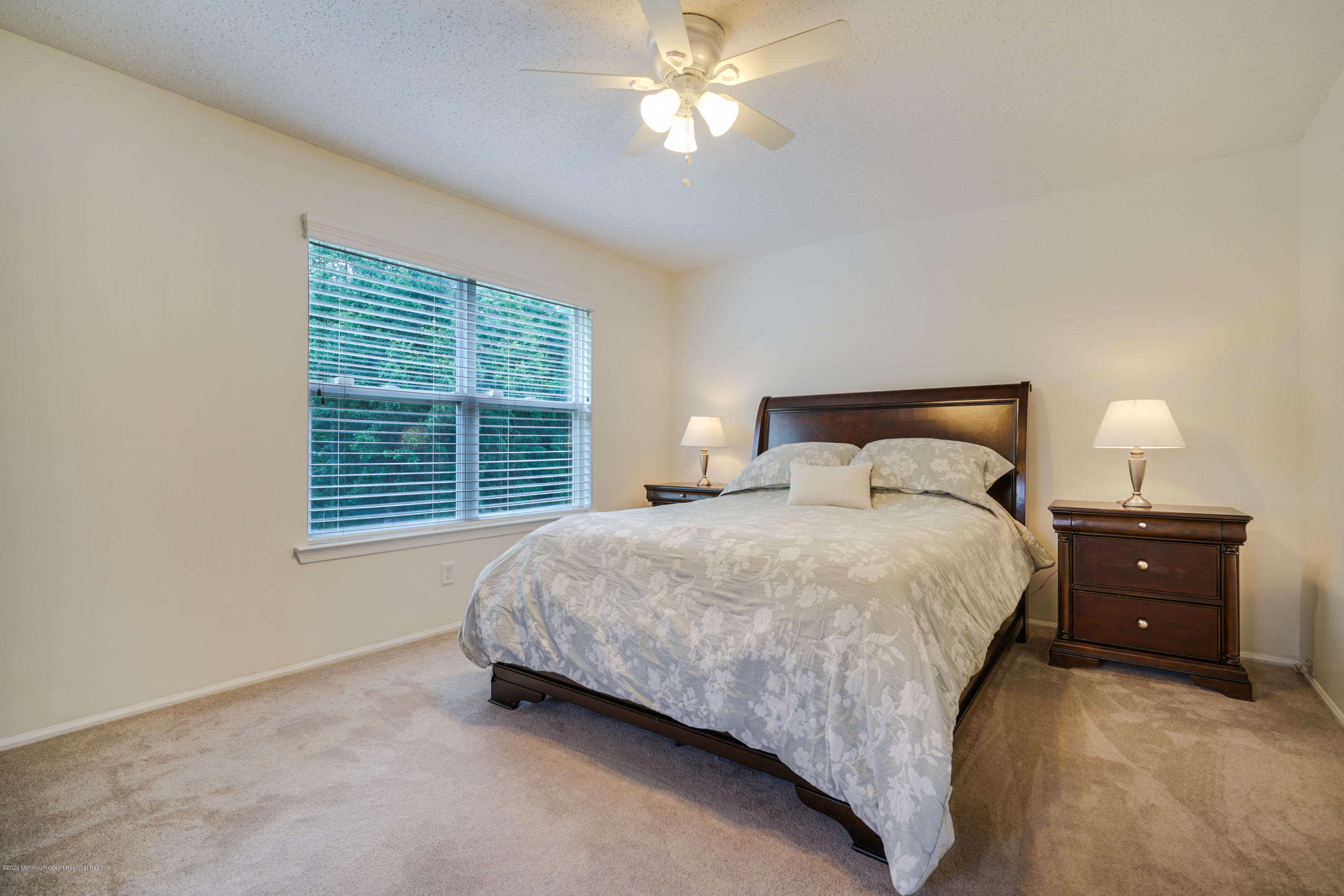689 Line Road Matawan, NJ 07747 - Photo 12 of 25 a bedroom with a bed and a chandelier