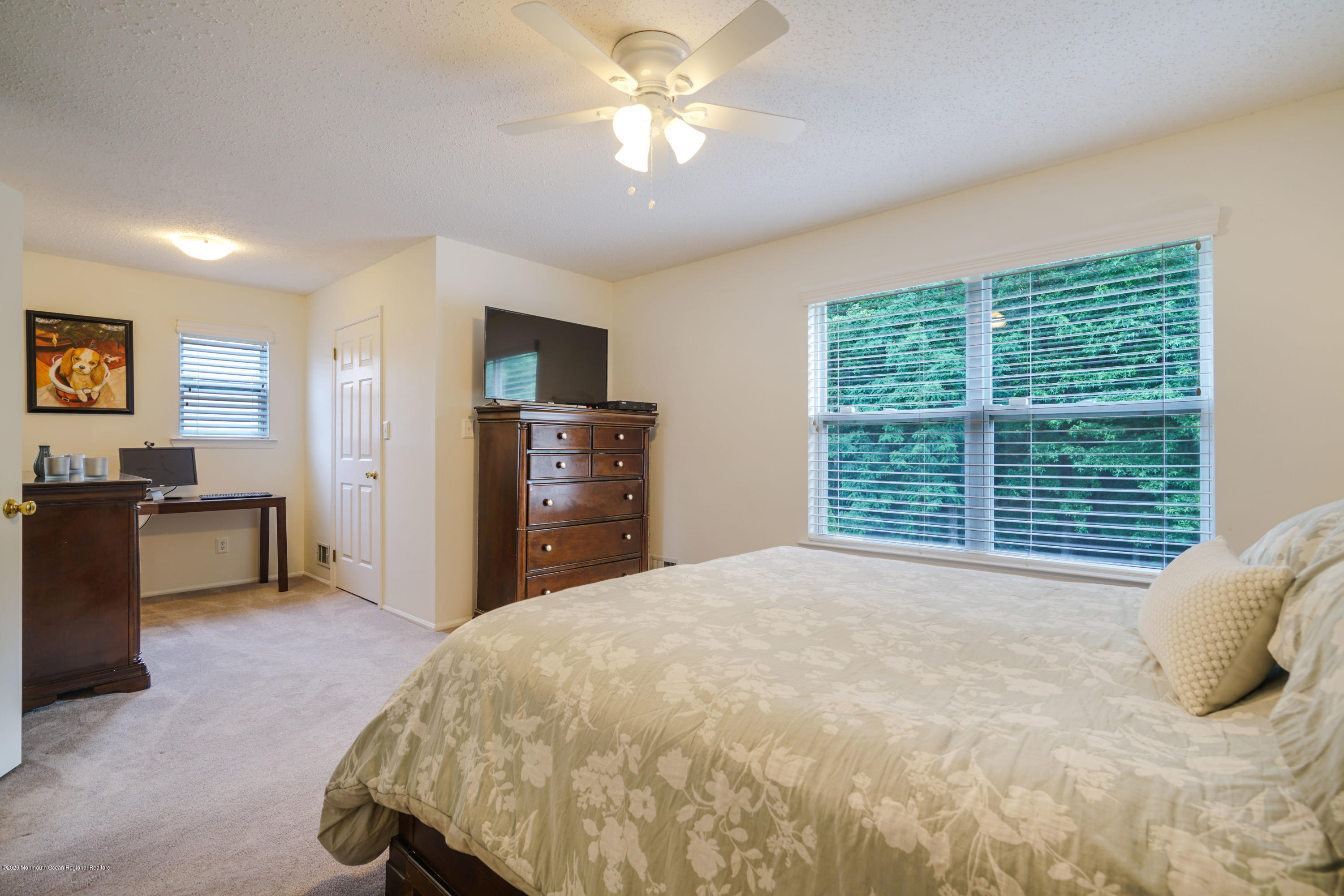 689 Line Road Matawan, NJ 07747 - Photo 13 of 25 a bedroom with a large bed and a chandelier