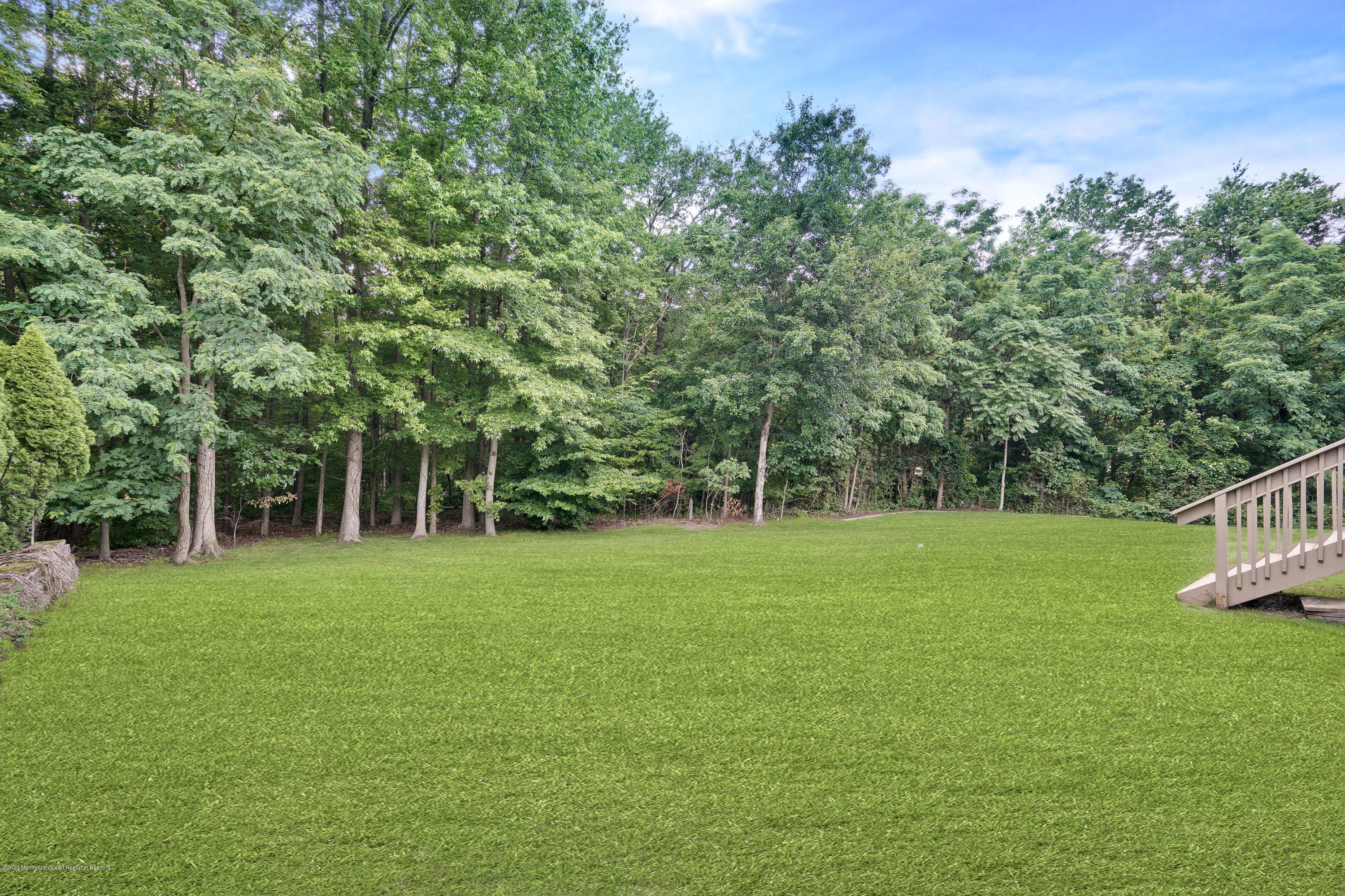689 Line Road Matawan, NJ 07747 - Photo 25 of 25 a view of a grassy field with trees in the background