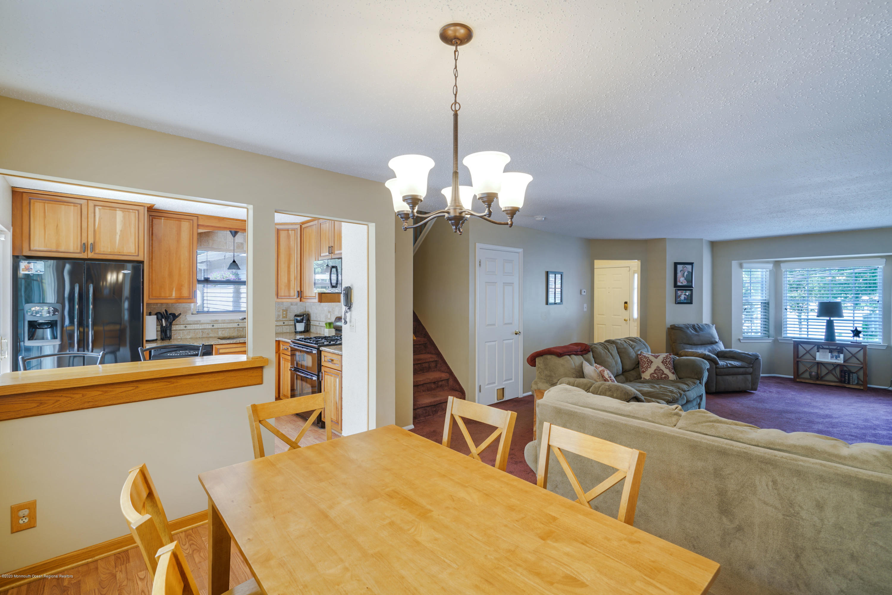 689 Line Road Matawan, NJ 07747 - Photo 6 of 25 a living room with fireplace furniture and a chandelier