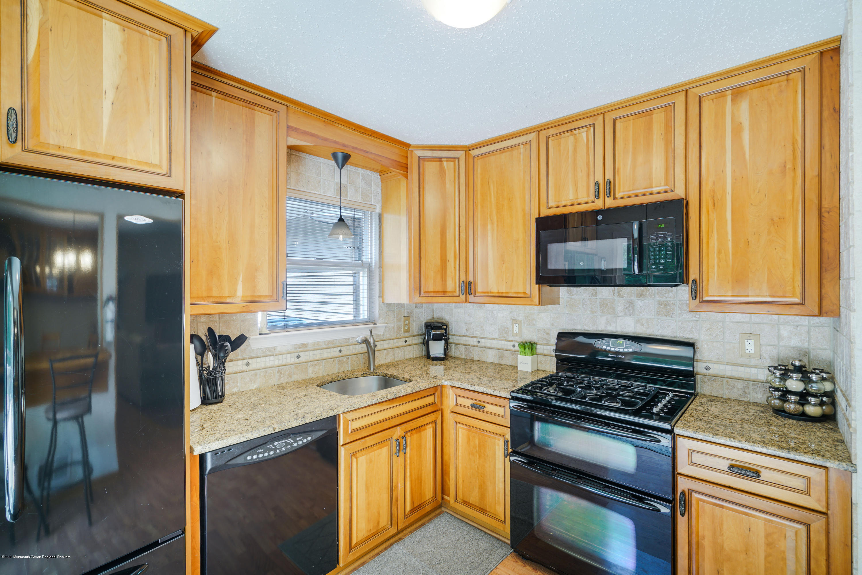 689 Line Road Matawan, NJ 07747 - Photo 8 of 25 a kitchen with stainless steel appliances granite countertop a stove a sink and a microwave