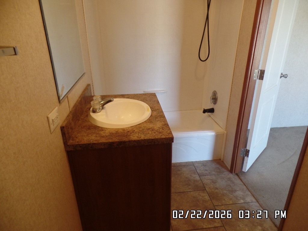 686 Ramar Road Bullhead City, AZ 86442 - Photo 21 of 22 a bathroom with a granite countertop sink and mirror