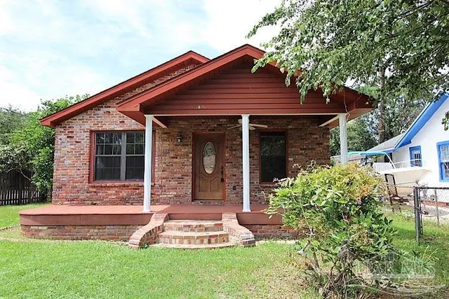 a front view of a house with a yard and porch