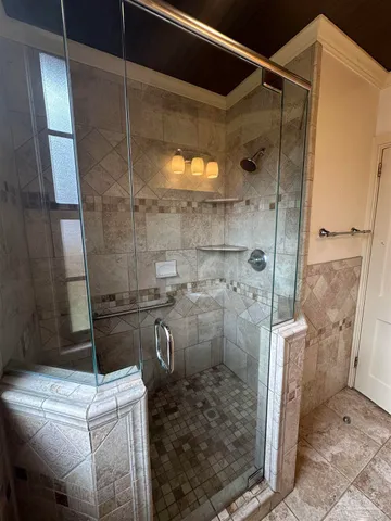 a bathroom with a granite countertop sink a toilet and shower