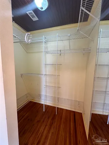 a view of a room with wooden floor and white walls