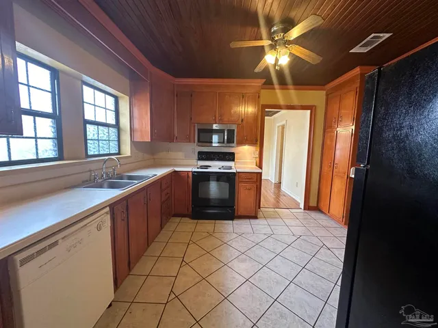 a kitchen with stainless steel appliances a sink and a refrigerator