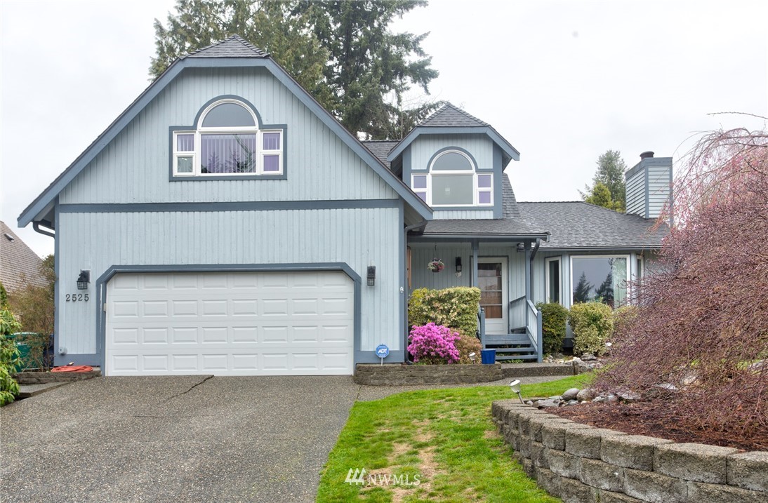 2525 166th Place Southeast Bothell, WA 98012 - Photo 1 of 25 a front view of a house with garden