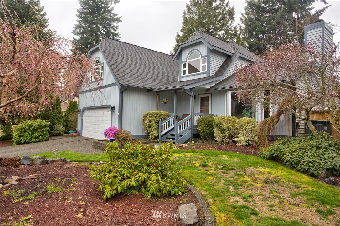 2525 166th Place Southeast Bothell, WA 98012 - Photo 22 of 25 a front view of a house with a yard and garage