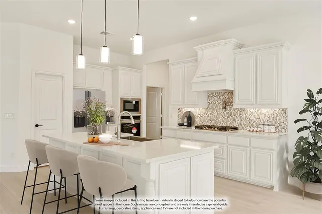 a kitchen with stainless steel appliances kitchen island granite countertop a table and chairs in it