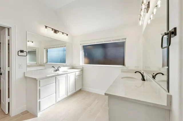 a bathroom with a sink double vanity and mirror