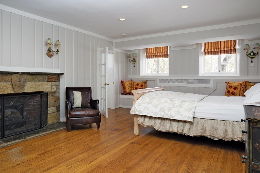 95 Clinton Road Brookline, MA 02445 - Photo 16 of 19 a bedroom with a bed a fireplace and a window