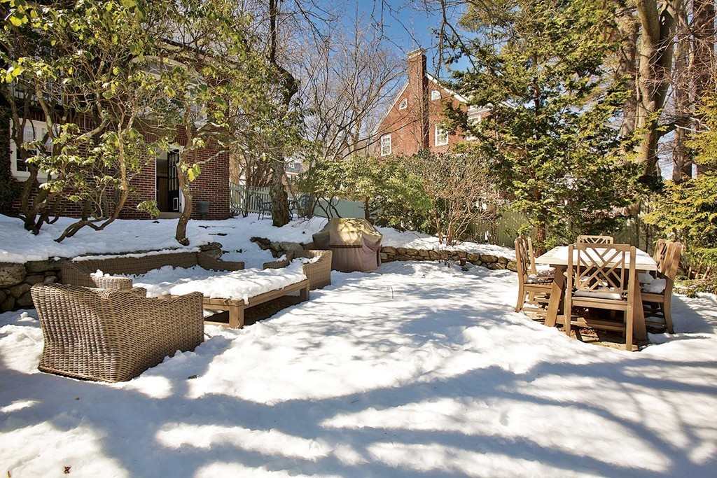 95 Clinton Road Brookline, MA 02445 - Photo 19 of 19 a view of a patio with table and chairs with wooden fence and plants