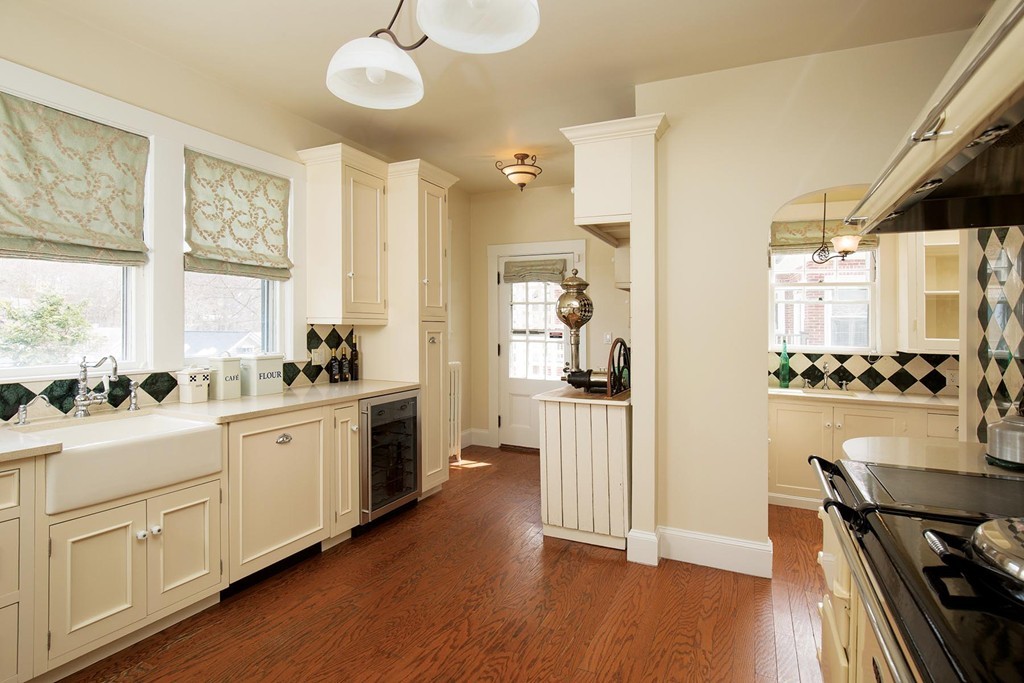 95 Clinton Road Brookline, MA 02445 - Photo 7 of 19 a kitchen with a white cabinets and stove top oven