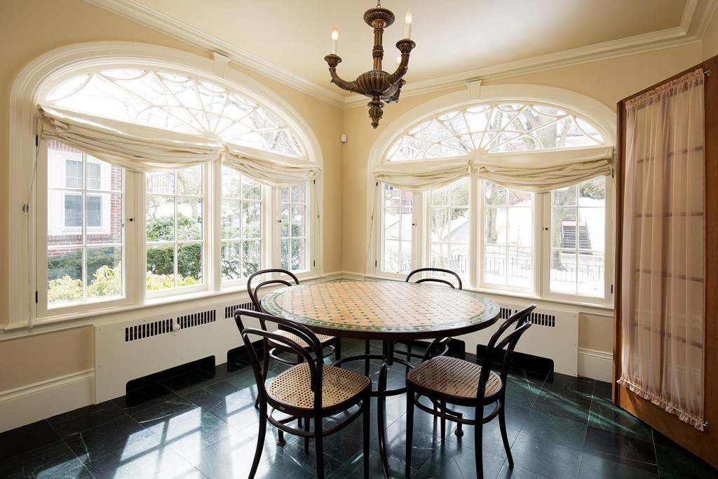 95 Clinton Road Brookline, MA 02445 - Photo 9 of 19 a dining room with wooden floor a chandelier a wooden table and chairs