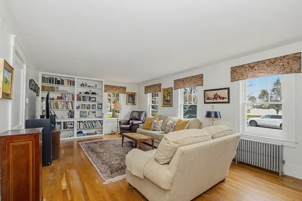 a living room with furniture and a book shelf