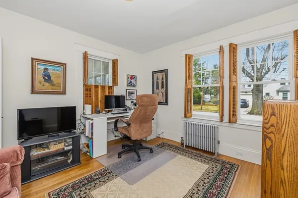 a view of a livingroom with workspace and a window