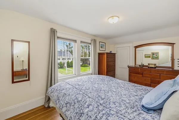 a bedroom with a large bed and a dresser