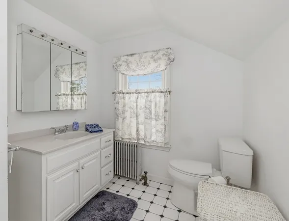 a bathroom with a sink toilet vanity and tub