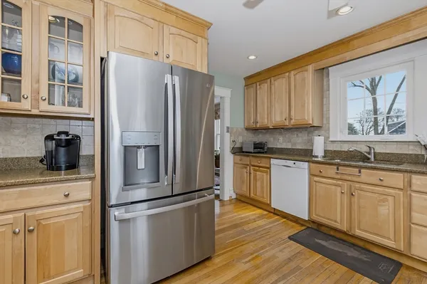 a kitchen with stainless steel appliances a refrigerator sink and cabinets
