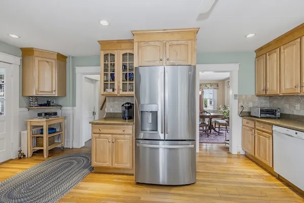 a kitchen with a refrigerator and a stove top oven