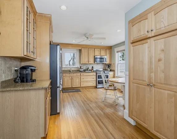 a kitchen with a refrigerator a sink and a cabinets