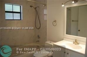 10631 Northwest 14th Street, Unit 229 Plantation, FL 33322 - Photo 12 of 12 a bathroom with a granite countertop sink a mirror and a shower