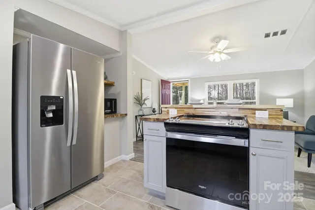 a kitchen with stainless steel appliances granite countertop a stove and a refrigerator