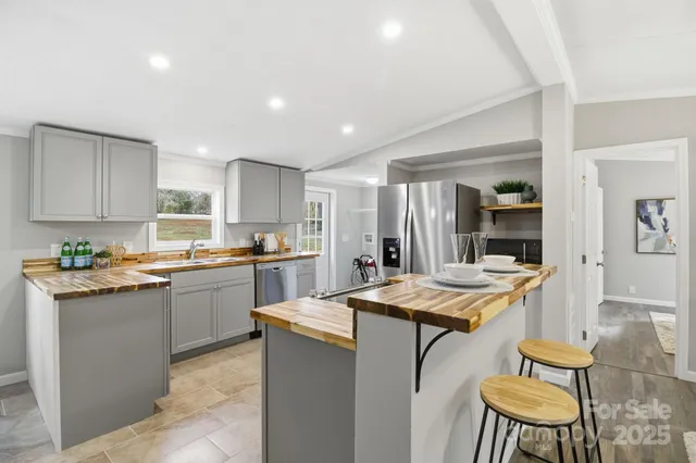 a kitchen with a table chairs sink and cabinets