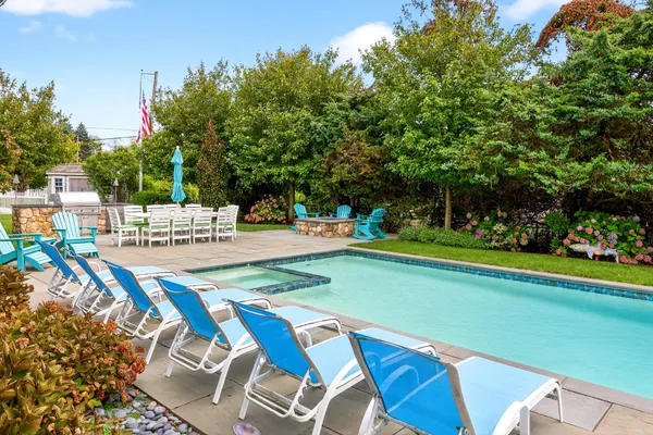 a bedroom with a bed and a couch with wooden floor