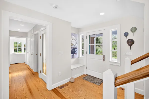 a bathroom with a granite countertop sink a toilet and a window