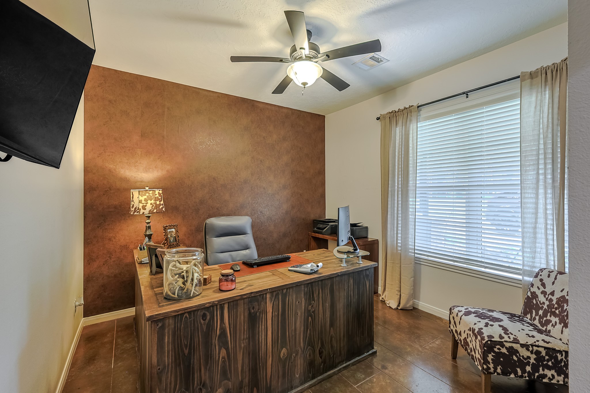 6409 Medley Road New Waverly, TX 77358 - Photo 26 of 50 This secondary bedroom is currently being used as an office has a large window overlooking the pond. The beautiful accent wall is wallpaper that will not damage the wall if removed.