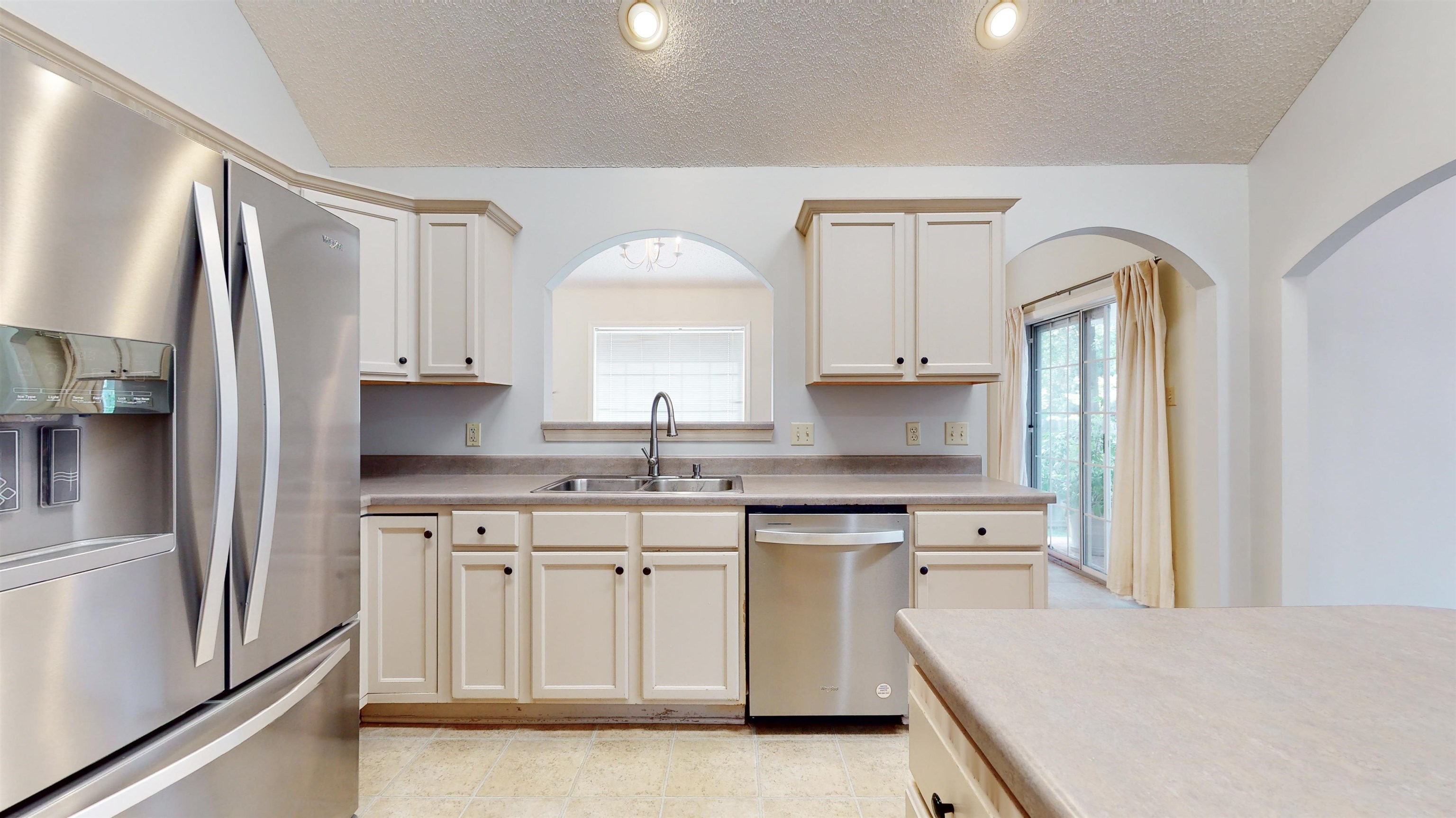 195 Cross Point Drive Collierville, TN 38017 - Photo 7 of 40 a kitchen with white cabinets and stainless steel appliances
