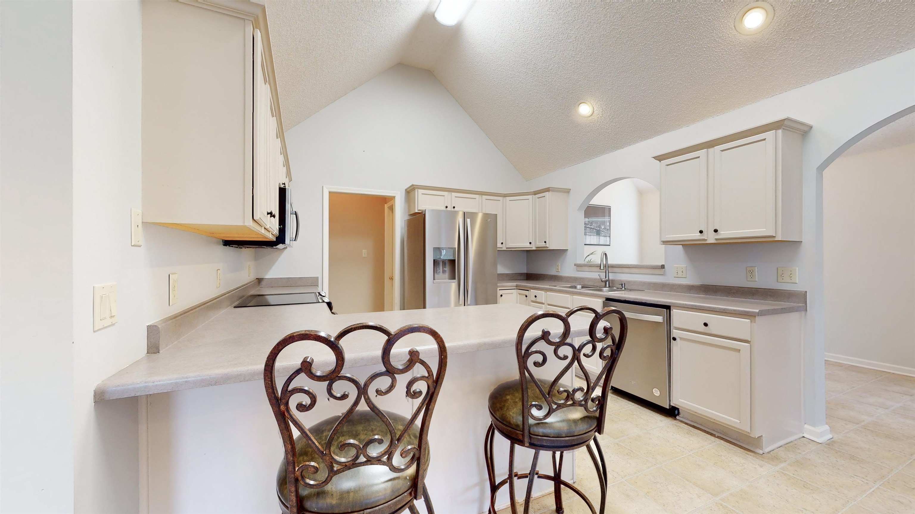 195 Cross Point Drive Collierville, TN 38017 - Photo 9 of 40 a kitchen with stainless steel appliances granite countertop a sink and a stove top oven
