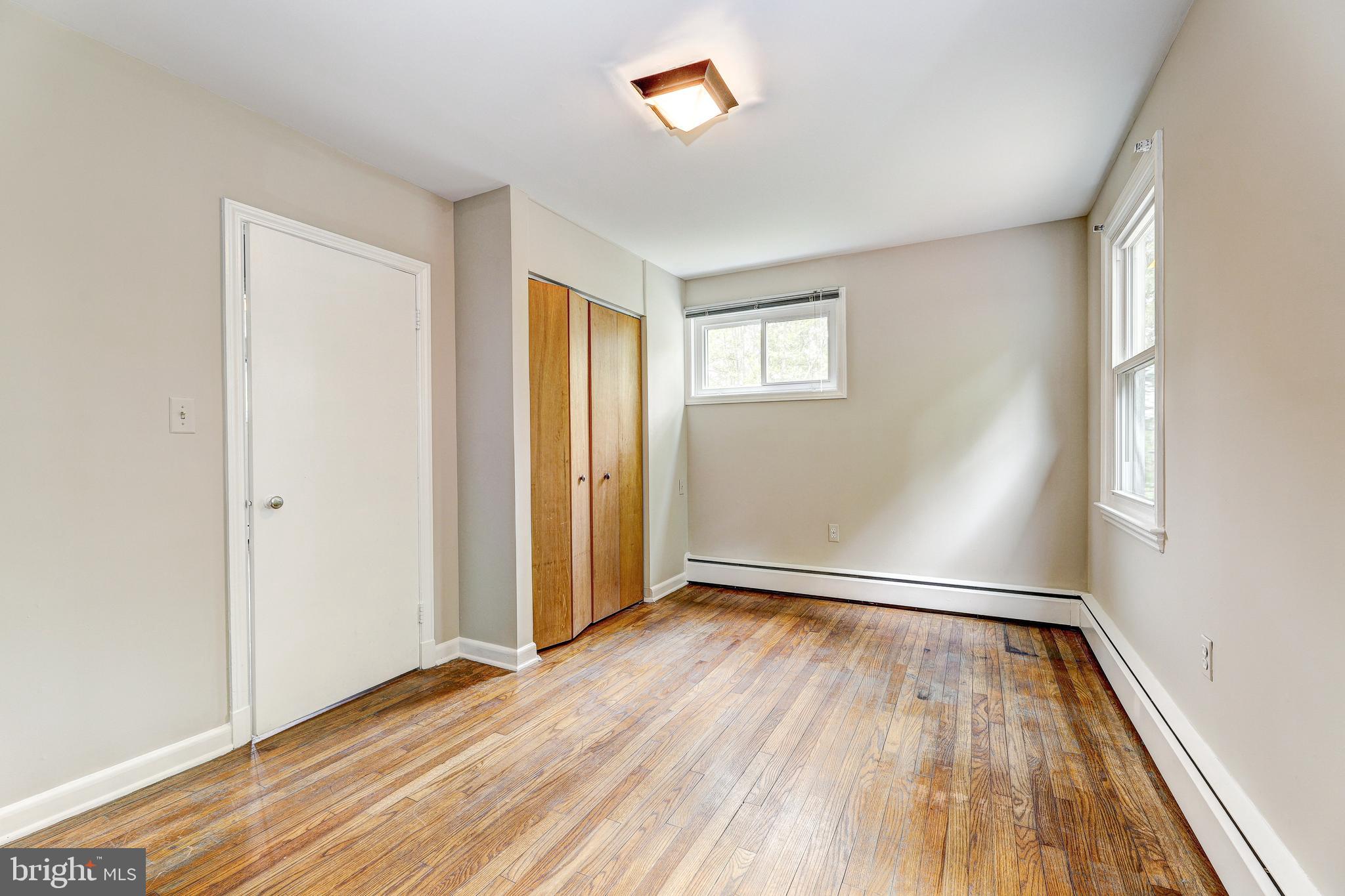 7500 Rocksham Drive Towson, MD 21286 - Photo 19 of 26 an empty room with wooden floor and windows