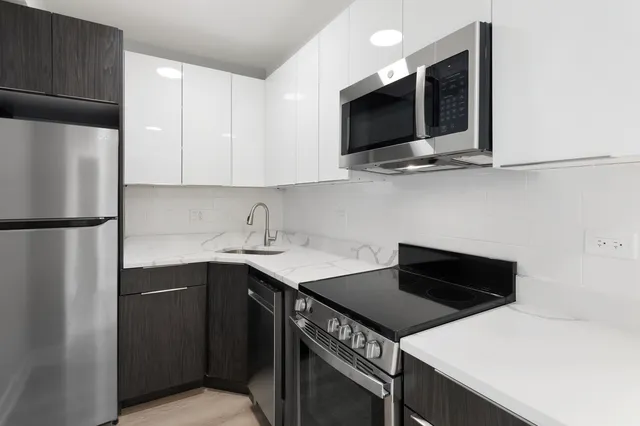 a kitchen with a sink and a refrigerator