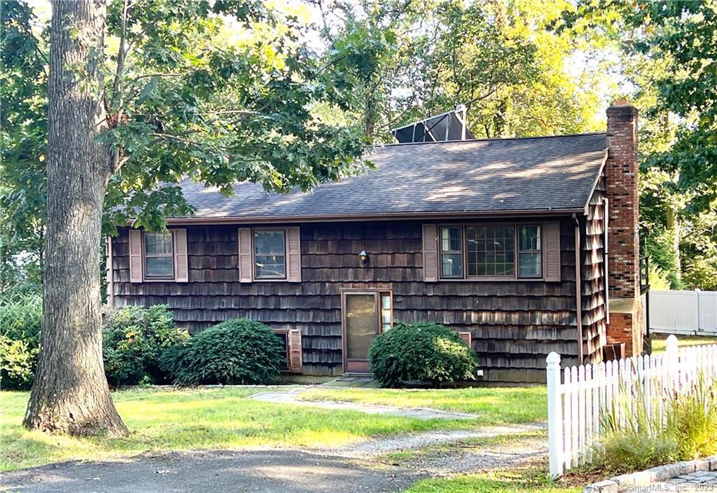 a front view of a house with yard and green space