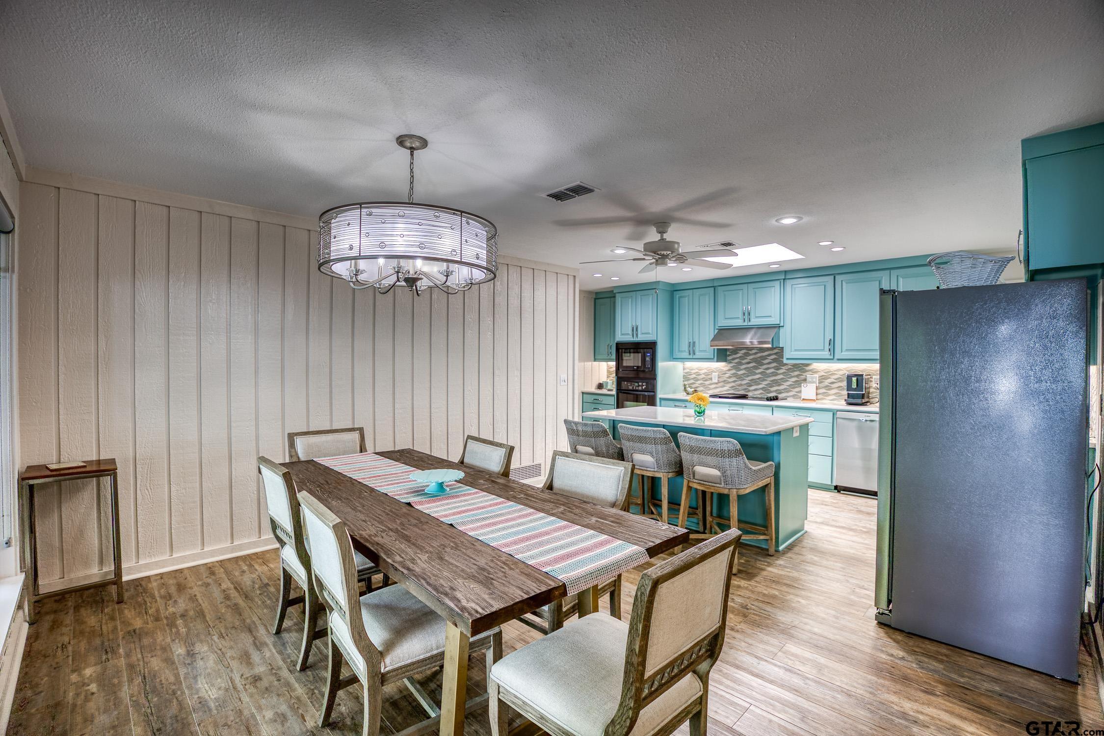 17553 Sleepy Hollow Way Flint, TX 75762 - Photo 11 of 41 a dining room with a table chairs and a kitchen view