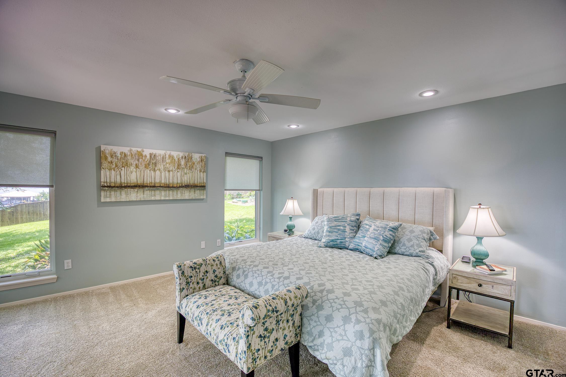 17553 Sleepy Hollow Way Flint, TX 75762 - Photo 16 of 41 a bedroom with a large bed chandelier and a window