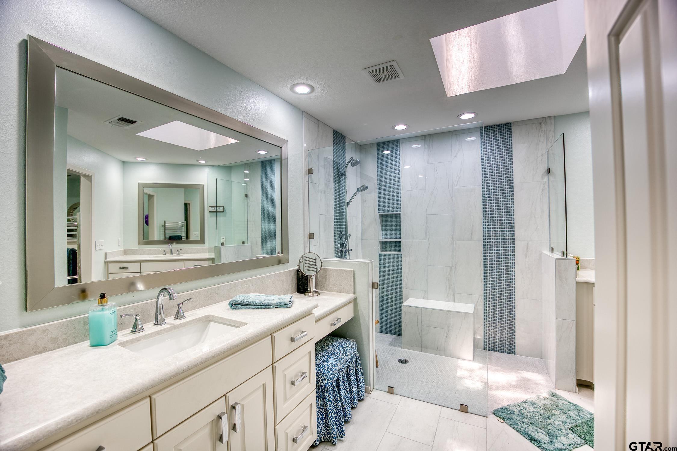 17553 Sleepy Hollow Way Flint, TX 75762 - Photo 18 of 41 a spacious bathroom with a shower sink double vanity and a mirror