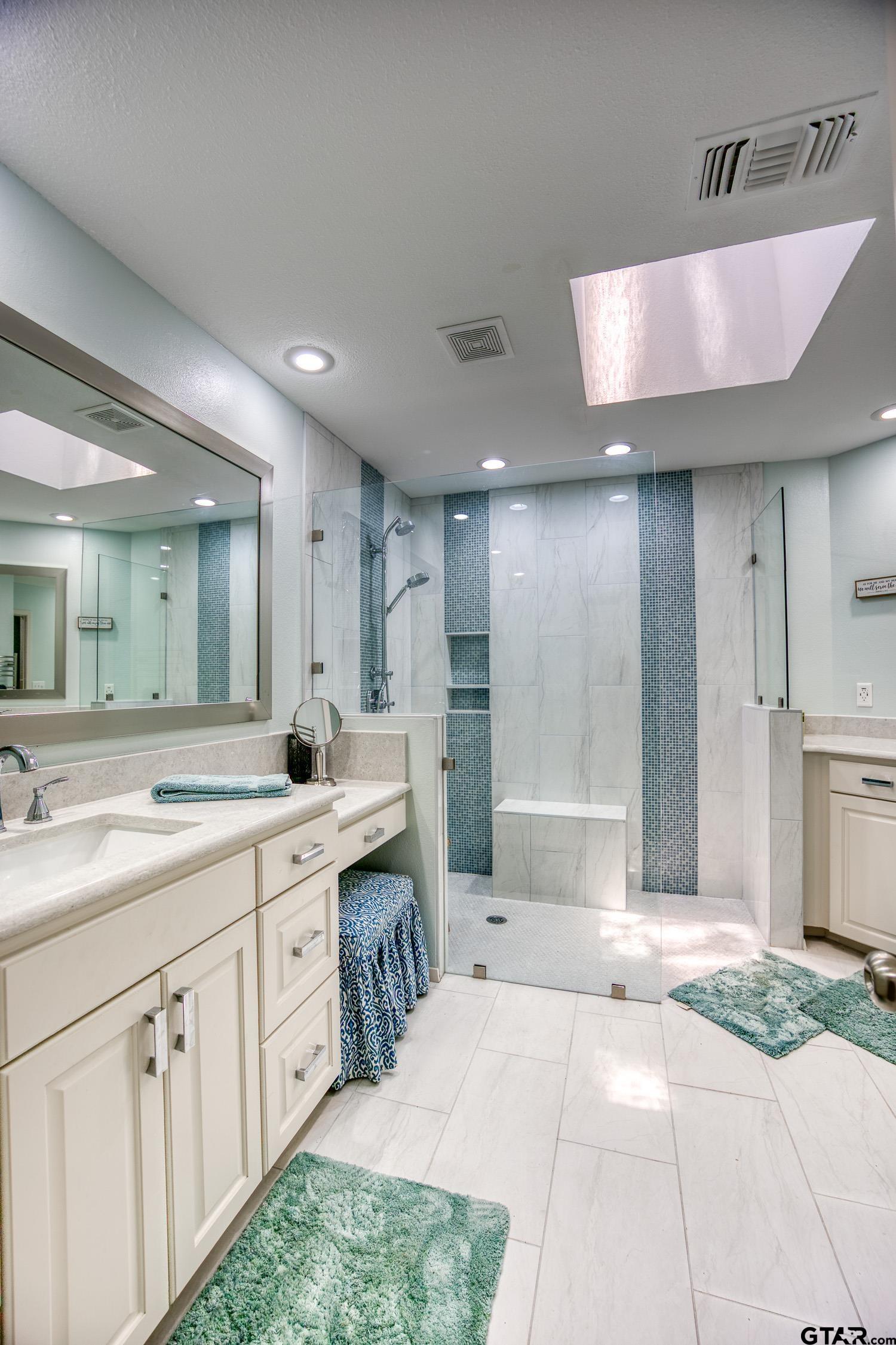 17553 Sleepy Hollow Way Flint, TX 75762 - Photo 19 of 41 a spacious bathroom with a sink a mirror and a shower