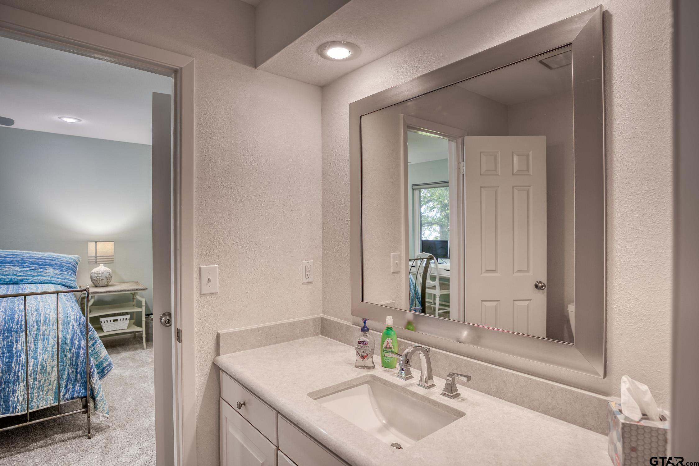 17553 Sleepy Hollow Way Flint, TX 75762 - Photo 25 of 41 a en suite bathroom with a sink and a mirror